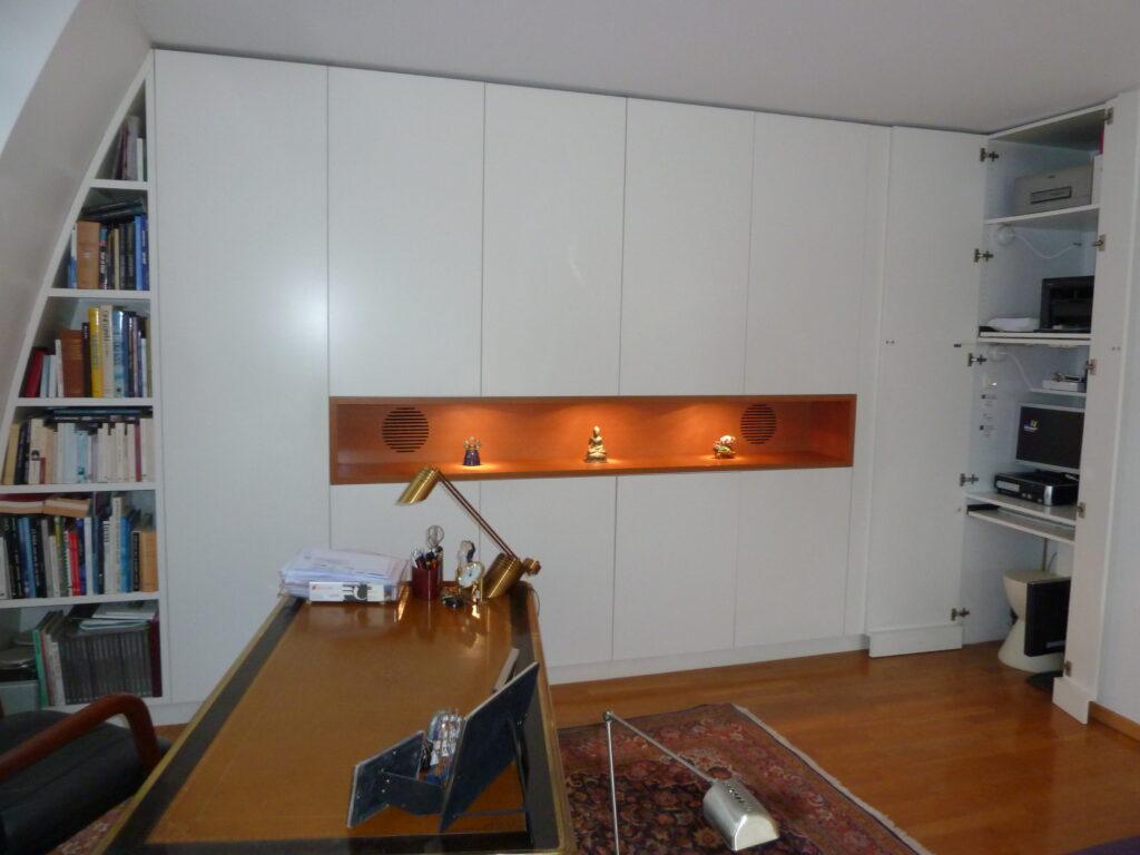 Agencement sur mesure par LDC Agencement – L’Arche du Bois : grande armoire avec étagères intégrées, bibliothèque à gauche, table devant l’armoire et rangement à droite.